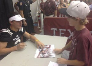 Johnny Manziel poisoning my son by being personable and friendly as he signs roughly his 490th autograph in 90 minutes. 